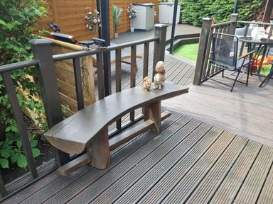 A garden with a wooden bench and figurines at Cabin Sleeps 4 with Hot Tub and Parking near Wilberfoss