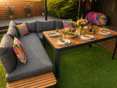 An outdoor dining area with a couch and table set for a meal at Cabin Sleeps 4 with Hot Tub and Parking near Wilberfoss