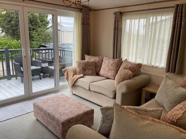 A living room with a sofa and ottoman at a property