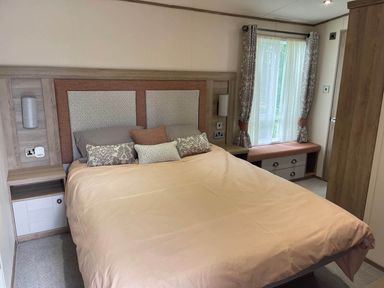 A bedroom with a bed and bedside table at 