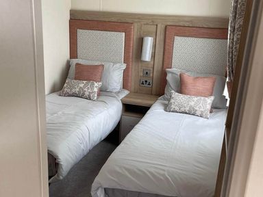 A bedroom with twin beds and a bedside table
