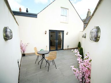 An outdoor patio with a table and chairs at Newly Refurbished Cottage, sleeping 4 and Central, Berwick-Upon-Tweed