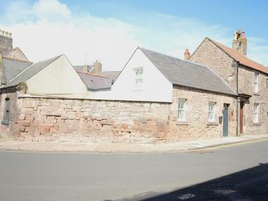A building with stone walls and sloped roof at Newly Refurbished Cottage, sleeping 4 and Central, Berwick-Upon-Tweed