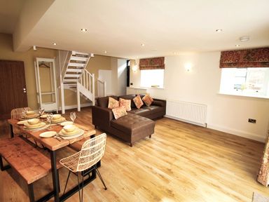 A living room with a dining area and staircase at Newly Refurbished Cottage, sleeping 4 and Central Berwick-Upon-Tweed