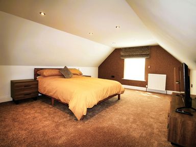 A bedroom with a bed and television in Newly Refurbished Cottage, sleeping 4 and Central Berwick-Upon-Tweed