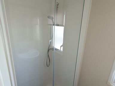 A shower and sink in the bathroom at Golden Sands 3-Bed Caravan, Parking and Pet Friendly Towyn
