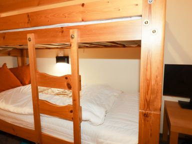 A bunk bed with mattress and bedding at Villa 12 near Camelford