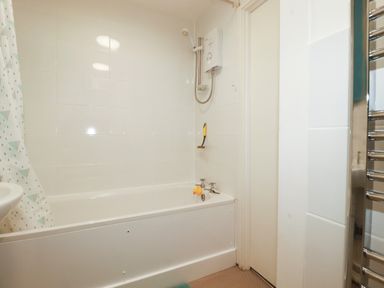A bathroom with a bathtub and shower fixture at Villa 12 near Camelford