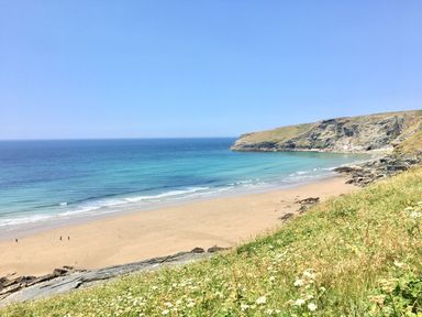 A beach with cliffs and ocean at Villa 12 near Camelford