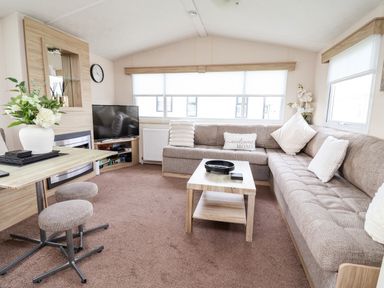 A living room with a sofa and TV at B54
