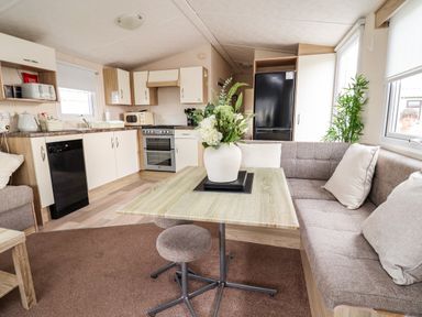 A kitchen with a table and sofa at B54 