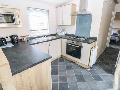 A kitchen with oven and sink at Seascape in Haverfordwest