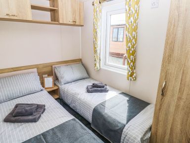 A bedroom with two beds and a window at Seascape in Haverfordwest