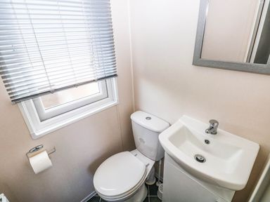 A bathroom with sink and toilet at Seascape in Haverfordwest