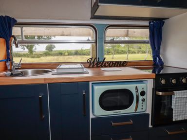 A kitchen with sink and appliances at Honey Bee Bus in Menheniot