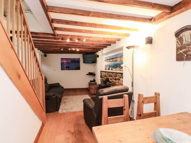 A living room with sofa and television at 2 bed Criccieth