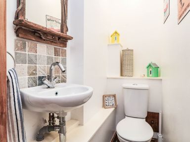 A bathroom with a sink and toilet at 2 bed Criccieth