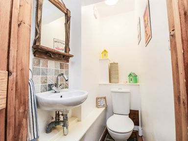A bathroom with a sink and toilet at 2 bed Criccieth