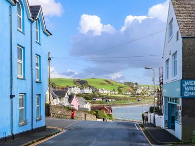 A street view with houses and hills at 2 bed Criccieth