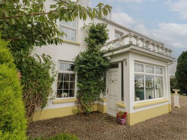 An exterior view of a house with a door and windows at Bruckless Rest Fine Country Dining B&amp;B Bruckless