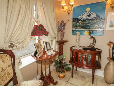 An entryway with a lamp and table displaying pictures at Bruckless Rest Fine Country Dining B&amp;B Bruckless