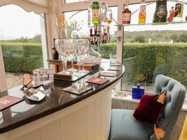 A bar counter with spirits bottles and wine glasses at Bruckless Rest Fine Country Dining B&amp;B in Bruckless