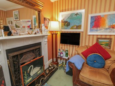 A living room with a fireplace and a sofa at Bruckless Rest Fine Country Dining B&amp;B Bruckless