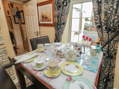 A dining table set with tea cups and a milk jug at Bruckless Rest Fine Country Dining B&amp;B in Bruckless