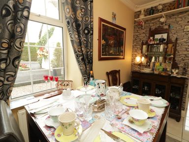 A dining room with a table set for tea at Bruckless Rest Fine Country Dining B&amp;B, Bruckless