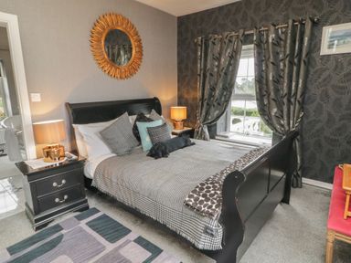 A bedroom with a bed and nightstand at Bruckless Rest Fine Country Dining B&amp;B Bruckless