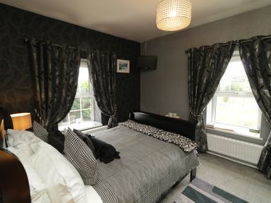 A bedroom with a bed and window at Bruckless Rest Fine Country Dining B&amp;B in Bruckless