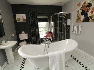 A bathroom with a bathtub and shower at Bruckless Rest Fine Country Dining B&amp;B in Bruckless