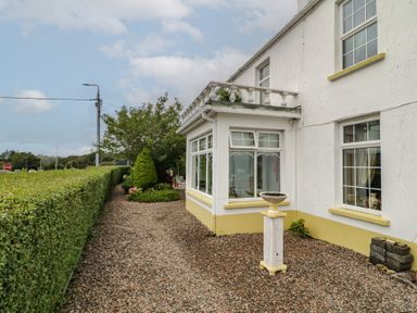 A house with a garden and pathway at Bruckless Rest Fine Country Dining B&amp;B Bruckless