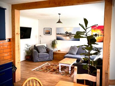 A living room with a sofa and table at Ty Marlyn in St Davids