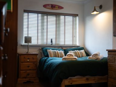 A bedroom with a bed and bedside table at Ty Marlyn in St Davids