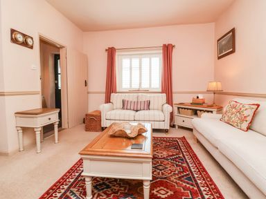 A living room with a sofa and coffee table at Myrtle Cottage in Lynmouth