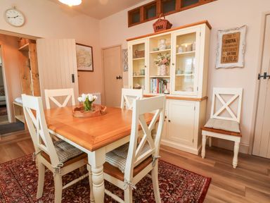A dining room with a table and chairs at Myrtle Cottage in Lynmouth
