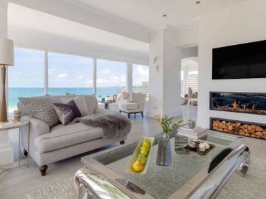 A living room with a sofa and coffee table at By The Sea in Newquay