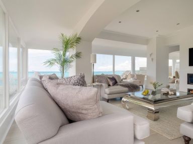 A living room with a sofa and coffee table at By The Sea in Newquay