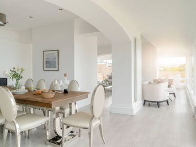 A dining room with a table and chairs at By The Sea in Newquay