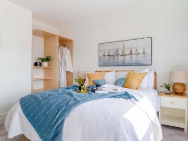 A bedroom with a bed and closet at By The Sea in Newquay