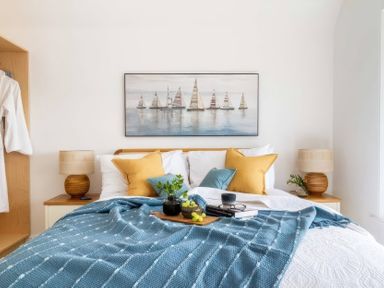 A bedroom with a bed and decorative elements at By The Sea in Newquay