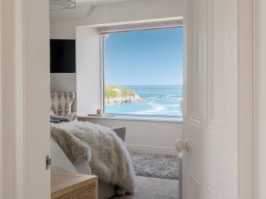 A bedroom with a view of the sea at By The Sea Newquay