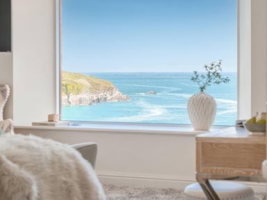 A living room with a view of the ocean at By The Sea in Newquay