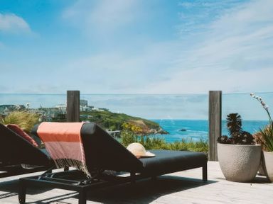 A chaise lounge with a hat and ocean view at By The Sea Newquay