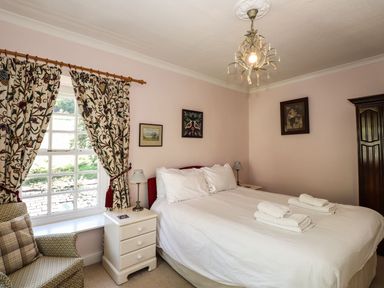A bedroom with a bed and nightstand at Jessicas Cottage in Windermere