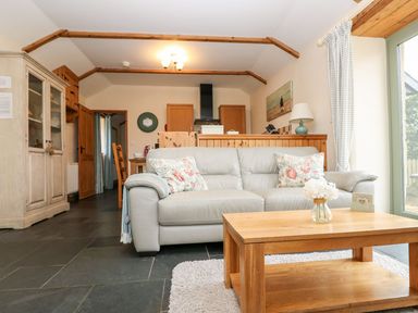 A living room with a sofa and coffee table at Beech Cottage in Truro