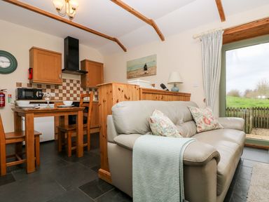 A kitchen with a dining table and appliances at Beech Cottage in Truro