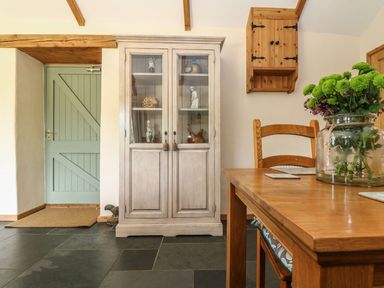 An entryway with a cabinet and table at Beech Cottage in Truro