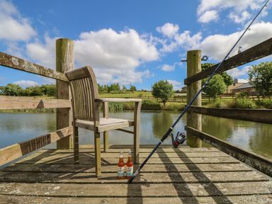A chair and fishing equipment at Beech Cottage in Truro